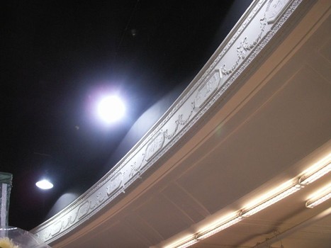 The Meserole Theater's decorative balcony is shrouded in mystery above the pharmacy counter.